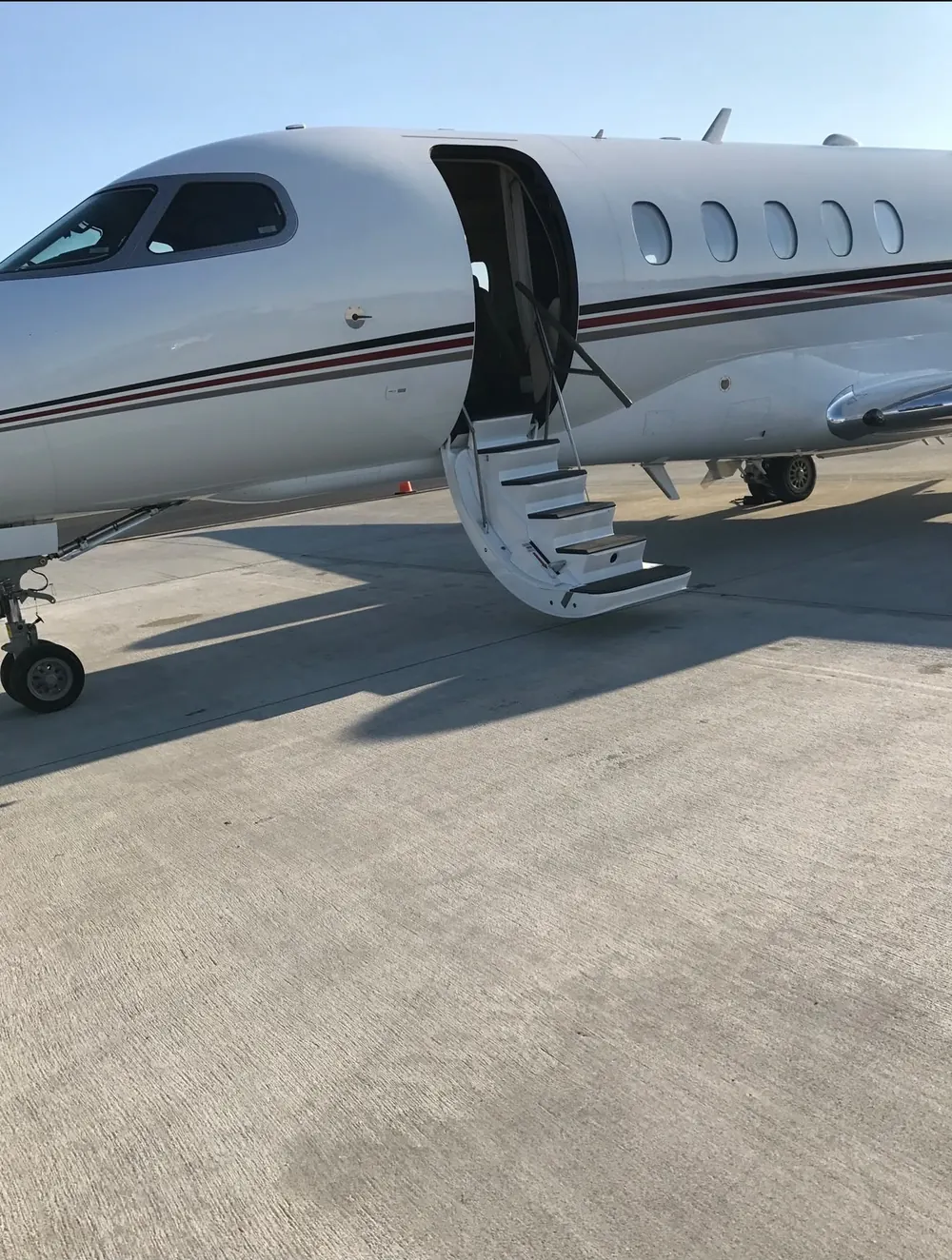 Citation with its airstair down on a sunny ramp
