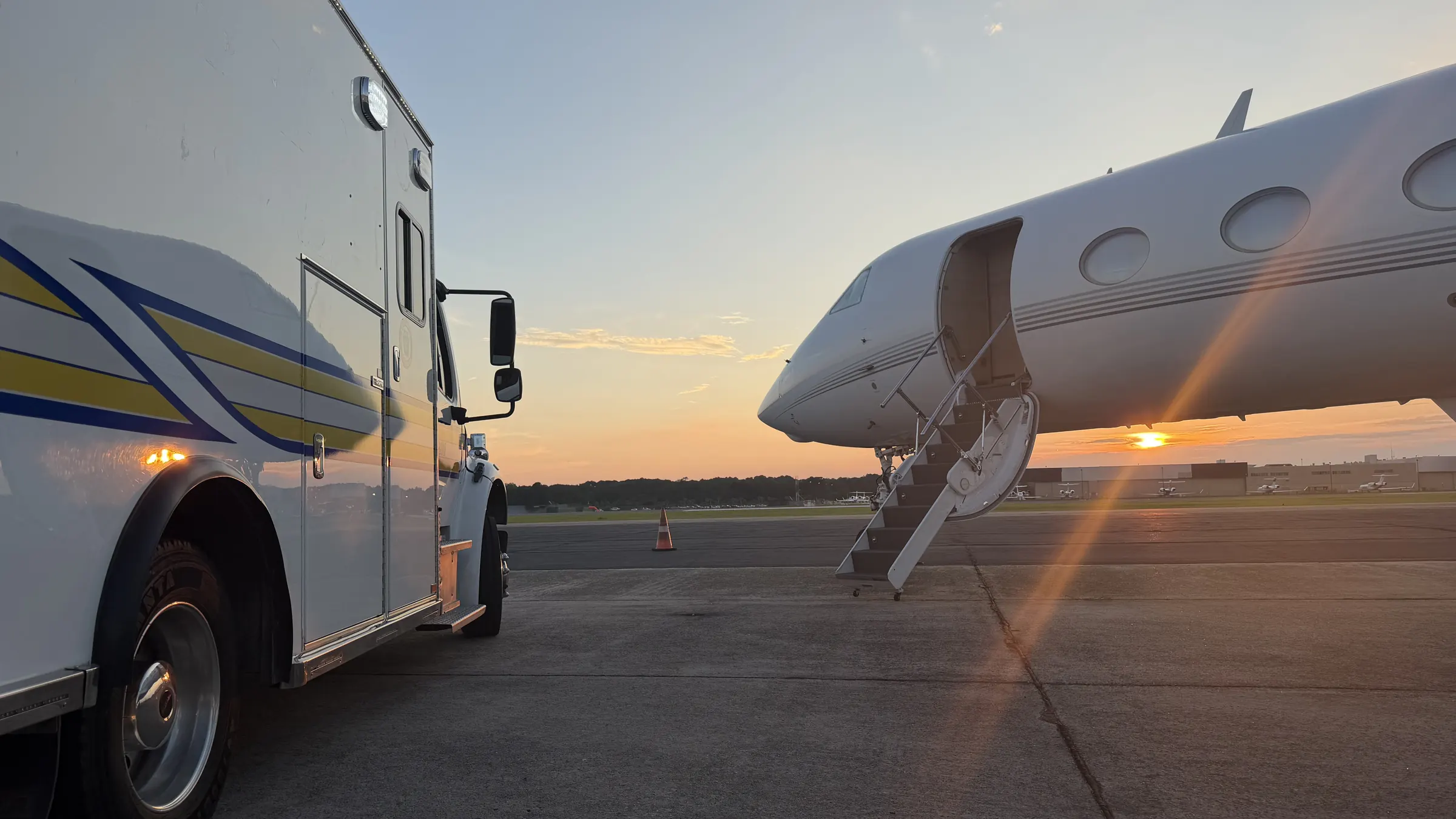 AOG truck beside a Gulfstream at sunset